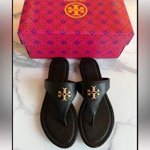 Black Tory Burch flip flop sandals with gold hardware